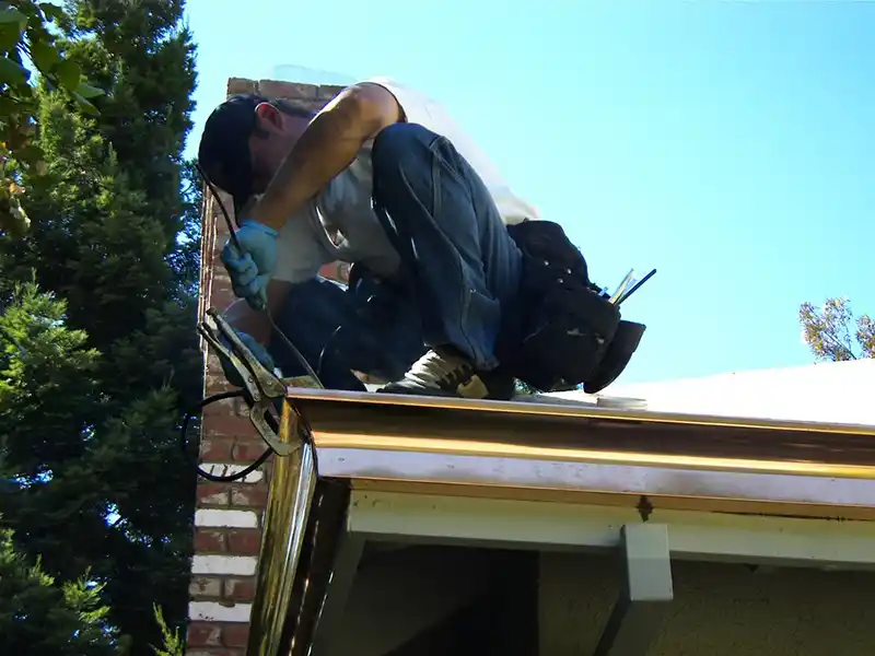 Worker installing new copper gutters